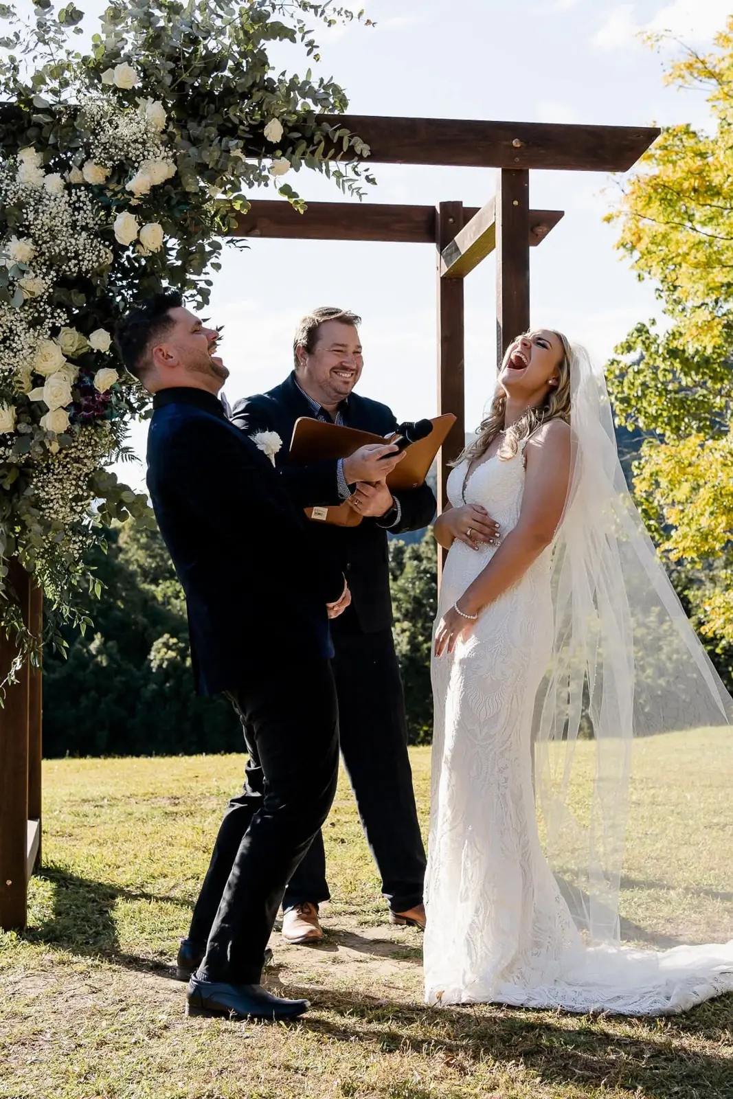 Couple and Ben laughing during a ceremony