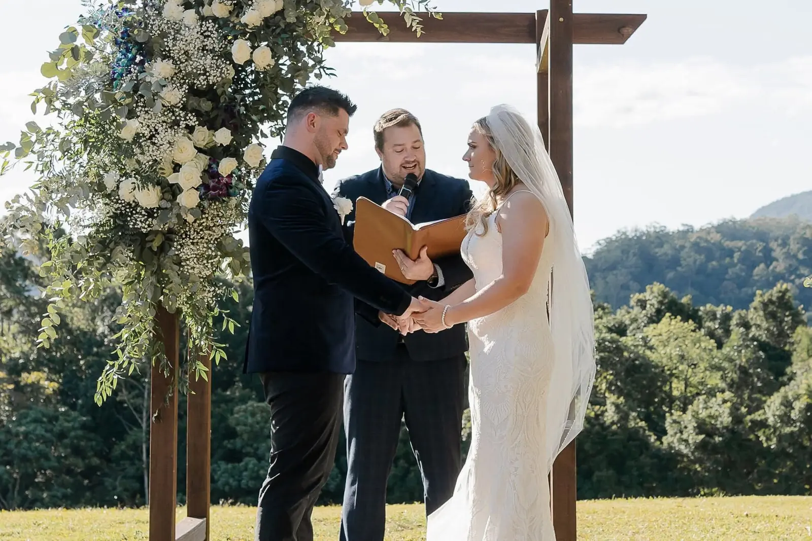 Ben officiating under a floral arbour in the Gold Coast hinterland