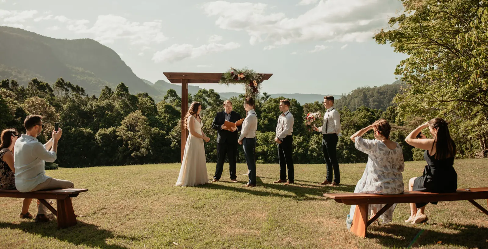 Wide view of a hinterland ceremony with mountains behind